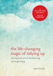 The cover of "The Life-Changing Magic of Tidying Up," featuring red text on a background of a blue sky with clouds