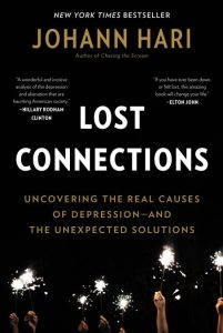 Cover of "Lost Connections," featuring several hands holding sparklers on a black background.