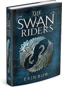 Cover of "The Swan Riders," featuring a dark blue background with two silver images of swans - their wings are spread and they are head-to-head, the negative space between them forming an S.