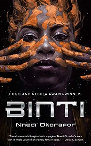 Cover of "Binti," featuring the face and hands of a woman with dark brown skin looking at the viewer and elegantly smearing red-brown mud on her face.