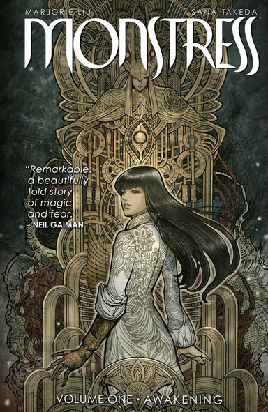 Cover of "Monstress Volume 1: Awakening," featuring a girl with long dark hair and one arm made of carved wood standing in front of a golden backdrop with ornate steampunk-style designs.