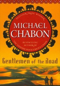 Cover of "Gentlemen of the Road," featuring desert sand dunes and the author's name in a red circle surrounded by a ring of elephant silhouettes.