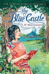 Cover of "The Blue Castle," featuring a girl with short black hair leaning against a tree and holding a book, with a blue cabin on an island in a lake behind her.