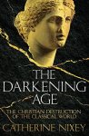 Cover of "The Darkening Age," featuring the broken-off head of a marble Greek statue with its nose chiseled off and a crude cross carved into its forehead.