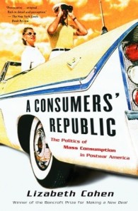 Cover of the book, featuring two white people in a white 50s-style convertible car with the top down. They are both looking backwards, and one of them is using a pair of binoculars.