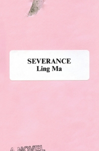 Cover of the book, featuring the title on a white sticker stuck on a pink wall; there is a chip in the paint near the top of the cover showing grayish wall beneath.