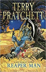 Cover of the book, featuring a skeleton in blue overalls and a straw hat holding a scythe and leaning against a tree in the middle of a wheat field.