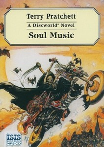 Cover of the book, featuring Death - a skeleton in a black cloak holding a scythe - jumping into the air on a motorcycle made mostly of bones, with golden wheels, a horse skull on the front, and a red guitar strapped to the side.