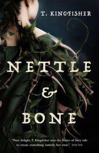 Cover of the book, showing half the back of a young woman with pale skin and long brown hair. She is wearing a green cloak twined with thorns, bones, and vines growing nettle leaves.